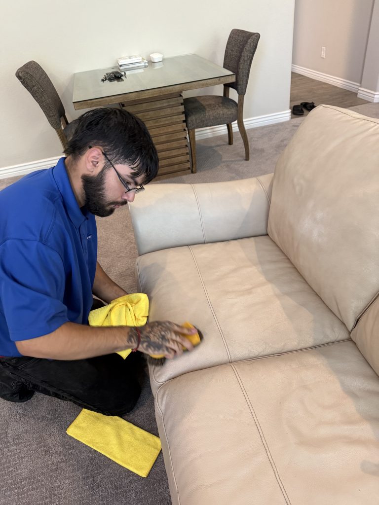Alpine technician cleaning a leather sofa